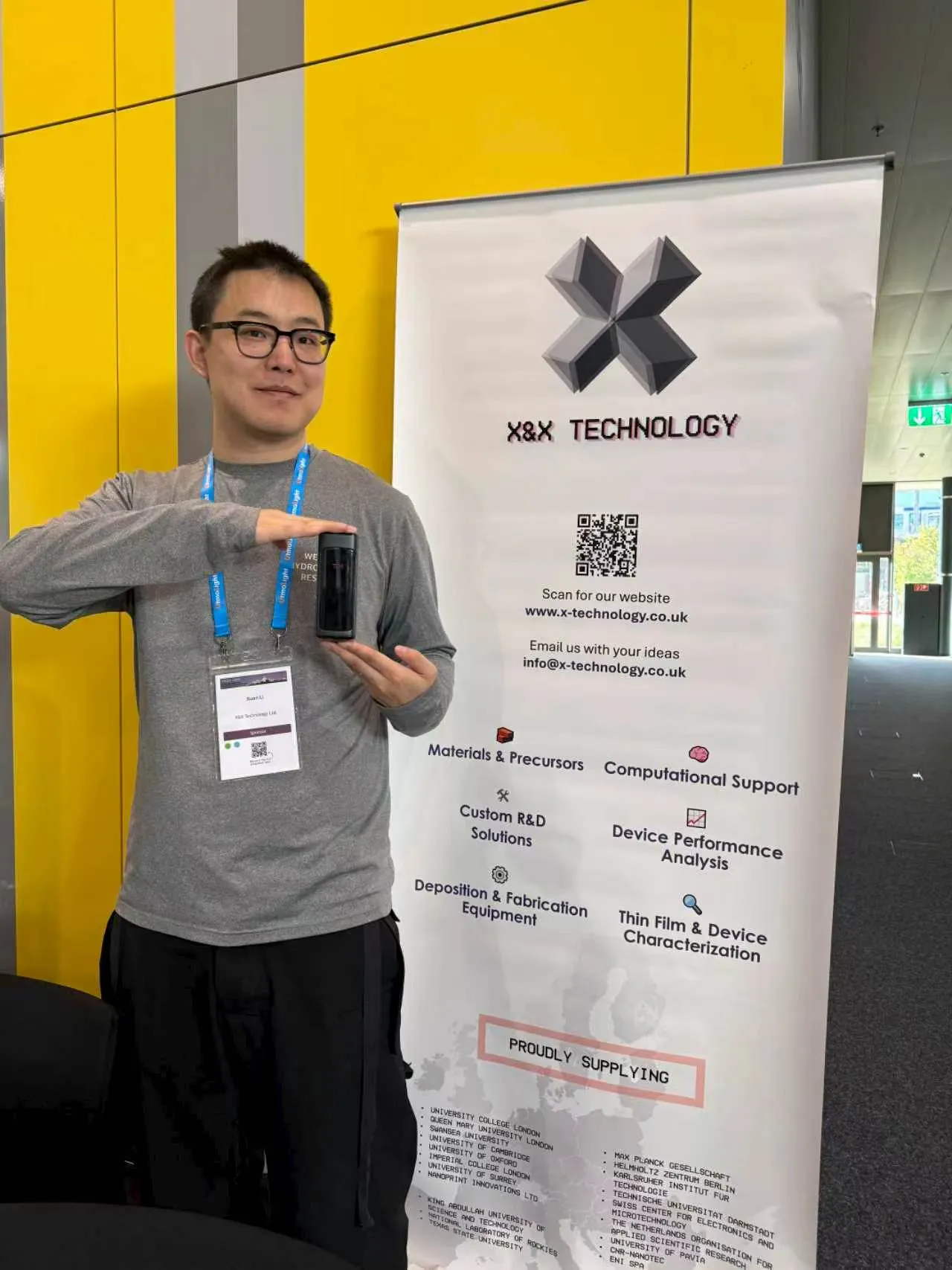 European partner holding TDM SE10 portable PL system beside K&X Technology banner at PSCO 2026